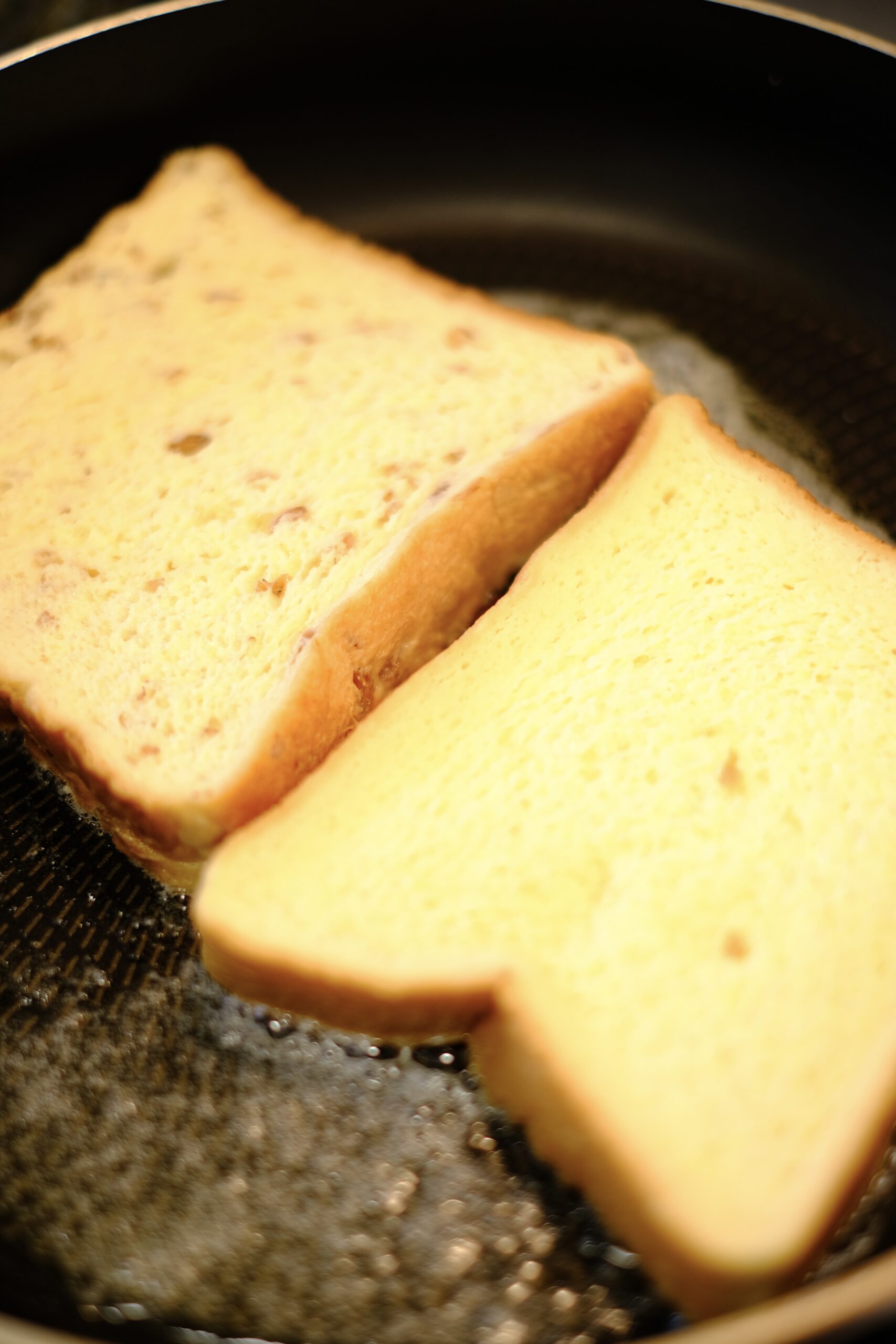 フライパンに漬け込んだパンを入れて焼いているようすの画像です
