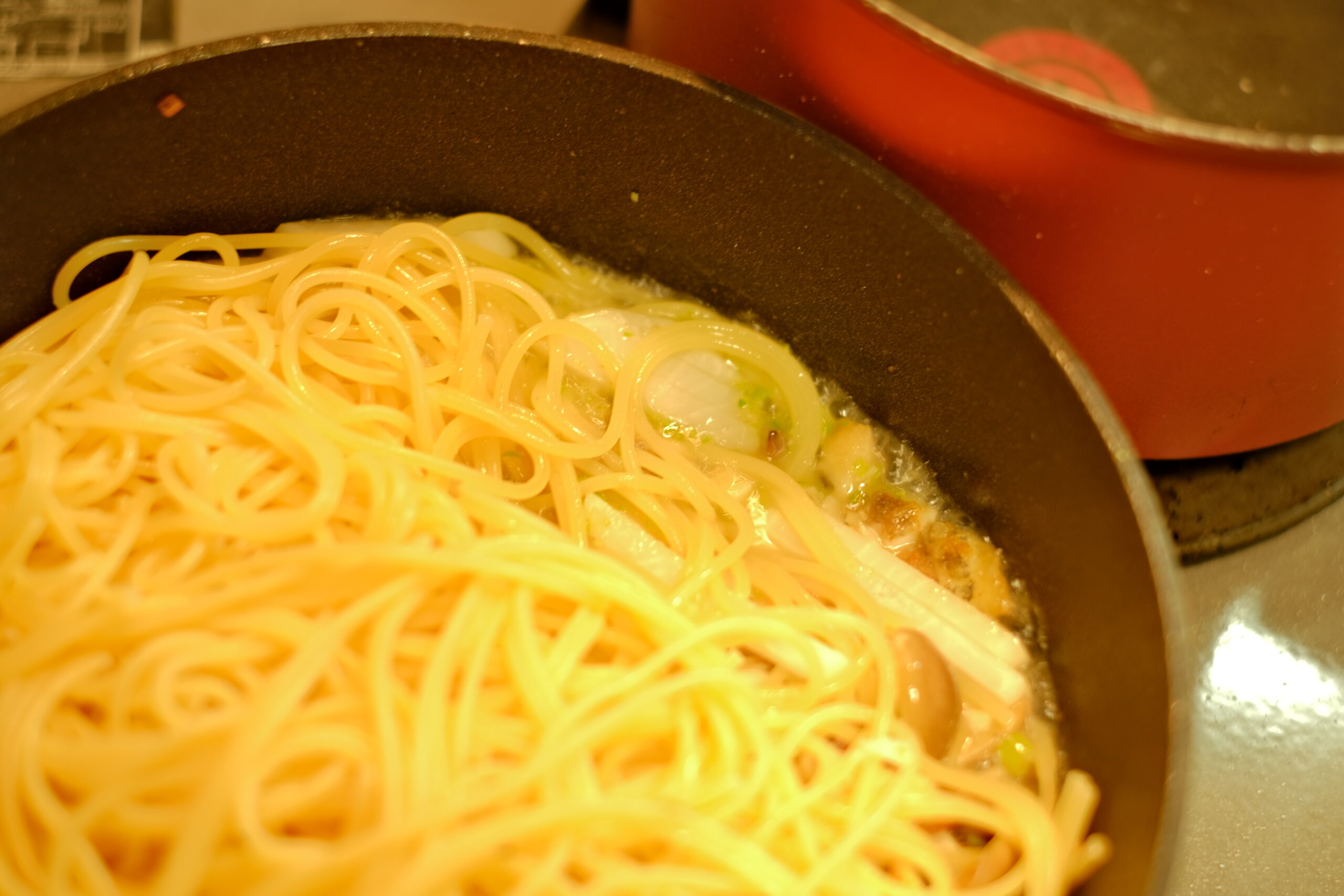 茹で上がったスパゲッティーニをソースの鍋に加える